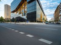 an empty city street with traffic and tall buildings in the background, in a city