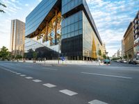 an empty city street with traffic and tall buildings in the background, in a city