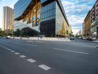 an empty city street with traffic and tall buildings in the background, in a city