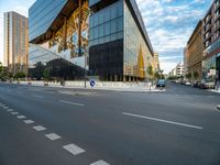 an empty city street with traffic and tall buildings in the background, in a city