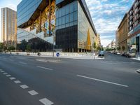 an empty city street with traffic and tall buildings in the background, in a city