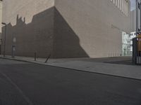 a large beige building next to a tall brick building on the street as if in another country, it is sunny