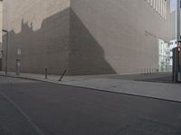 a large beige building next to a tall brick building on the street as if in another country, it is sunny