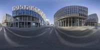 a fish eye lens is shown on the street in front of a building with a large glass window