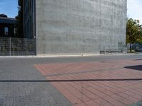 a brick path and stop sign in front of a building that has graffiti on the wall