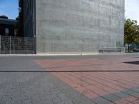 a brick path and stop sign in front of a building that has graffiti on the wall