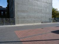 a brick path and stop sign in front of a building that has graffiti on the wall