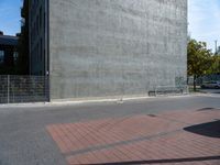 a brick path and stop sign in front of a building that has graffiti on the wall