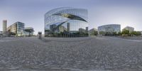 a view of some large buildings and some trees from a 360 - view lens of one of the buildings