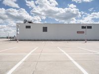 the building is in the middle of a parking lot with no vehicles or people in it