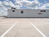 the building is in the middle of a parking lot with no vehicles or people in it