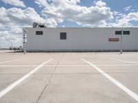 the building is in the middle of a parking lot with no vehicles or people in it