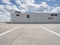 the building is in the middle of a parking lot with no vehicles or people in it