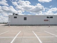 the building is in the middle of a parking lot with no vehicles or people in it