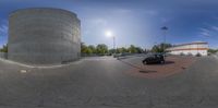 an upside down photo taken with a fish eye lens in a driveway intersection next to buildings