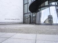 a white building with an interesting, geometric entrance mat in front of it's door