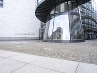 a white building with an interesting, geometric entrance mat in front of it's door