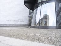 a white building with an interesting, geometric entrance mat in front of it's door