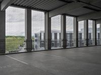 this is an empty floor in a building with large windows, as seen from behind the building