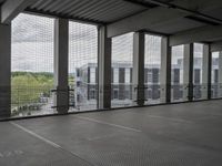 this is an empty floor in a building with large windows, as seen from behind the building