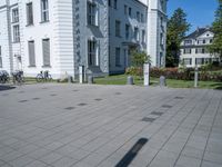 the shadows of buildings are cast from a shadow on the pavement near the street,