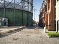 a large industrial water tank sits in front of the building site for an oil field