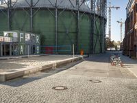 a large industrial water tank sits in front of the building site for an oil field