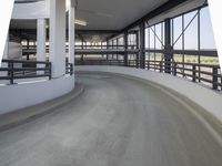 a walkway with railings on each side of it is empty with people walking around