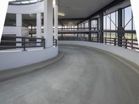 a walkway with railings on each side of it is empty with people walking around