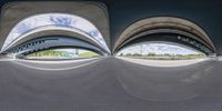 a photo taken from below a ramp with a few people riding bikes and a dog