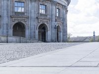 a person riding a skateboard on the street near buildings in city street park area