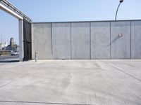 the empty parking lot is empty and concrete wall - like, which is a symbol of safety