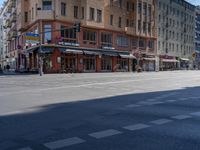 a street with two trains on it and a few people walking under an overpass