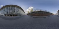 two panoramic photographs of a street with a bridge in the background and buildings and a sky in the distance