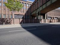 a skate board is in front of an empty road in front of a building with tall windows