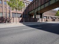 a skate board is in front of an empty road in front of a building with tall windows