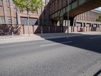 a skate board is in front of an empty road in front of a building with tall windows