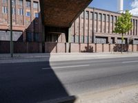a skate board is in front of an empty road in front of a building with tall windows
