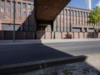 a skate board is in front of an empty road in front of a building with tall windows