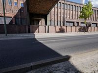 a skate board is in front of an empty road in front of a building with tall windows