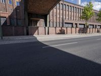 a skate board is in front of an empty road in front of a building with tall windows