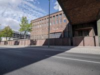 a skate board is in front of an empty road in front of a building with tall windows
