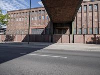 a skate board is in front of an empty road in front of a building with tall windows