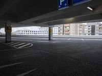 a view from an empty parking lot of an apartment complex at the edge of a parking lot