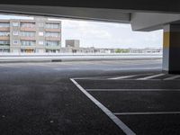 a view from an empty parking lot of an apartment complex at the edge of a parking lot