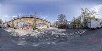 a halftone photo of a truck park under the bridge and its graffiti mural in the sky