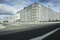 the empty parking lot with a large glass building in the background that says psp