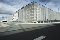 the empty parking lot with a large glass building in the background that says psp