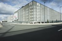 the empty parking lot with a large glass building in the background that says psp