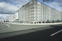 the empty parking lot with a large glass building in the background that says psp